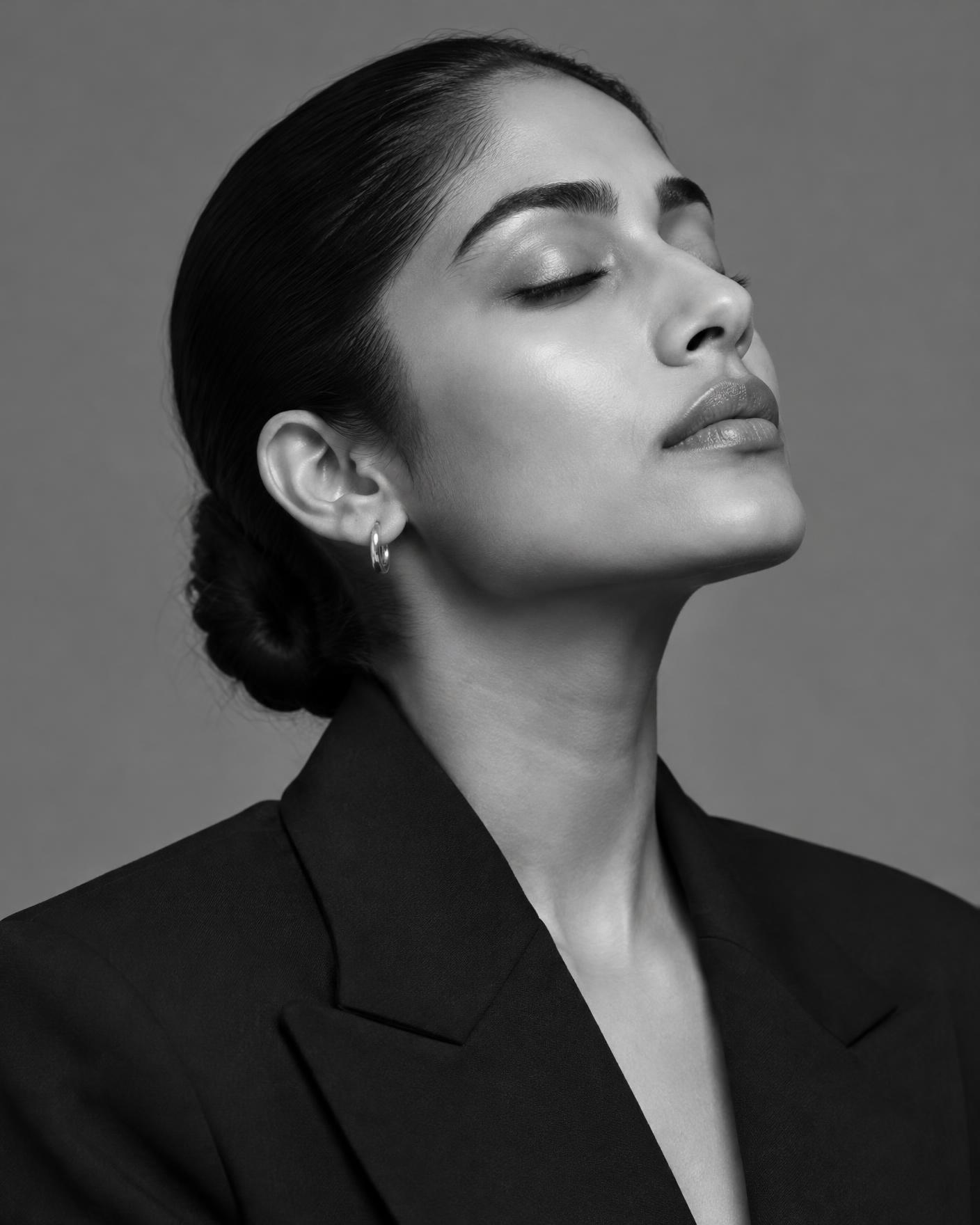 Editorial black and white portrait of a woman with smooth, clear skin